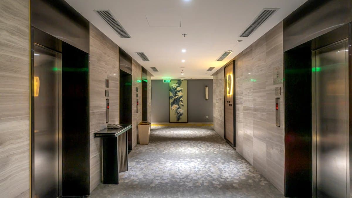 Contemporary hotel hallway with elevators and modern decor