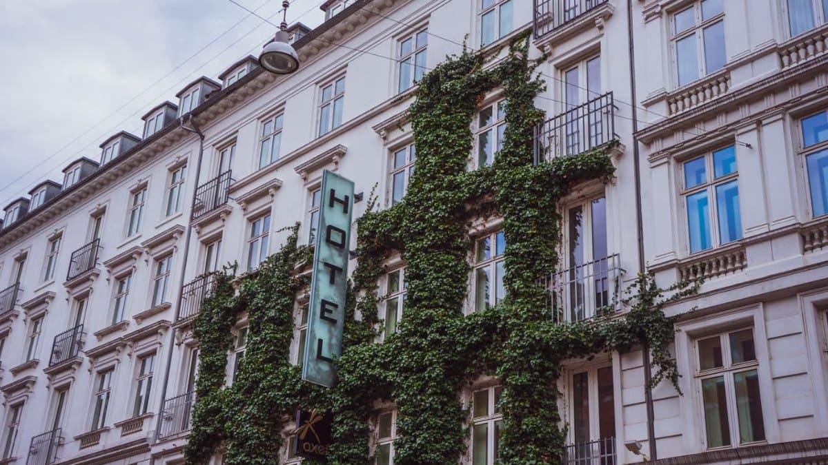 Elegant urban hotel facade covered in ivy on a city street