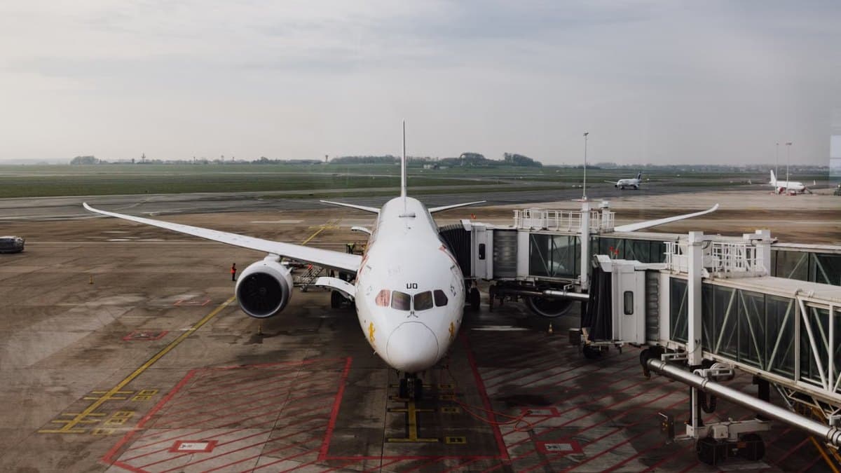 Modern jet airplane docked at an airport terminal gate ready for boarding