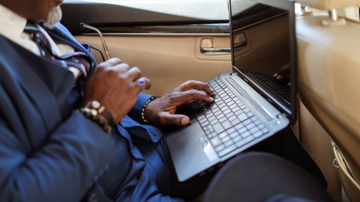 Executive travelling between meetings in a chauffeured car in Toronto