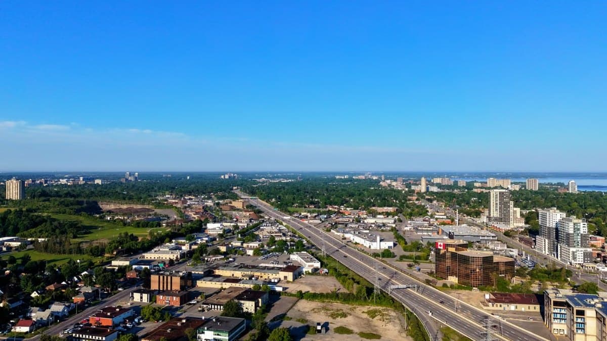Aerial view of a suburban cityscape with a major highway and green space