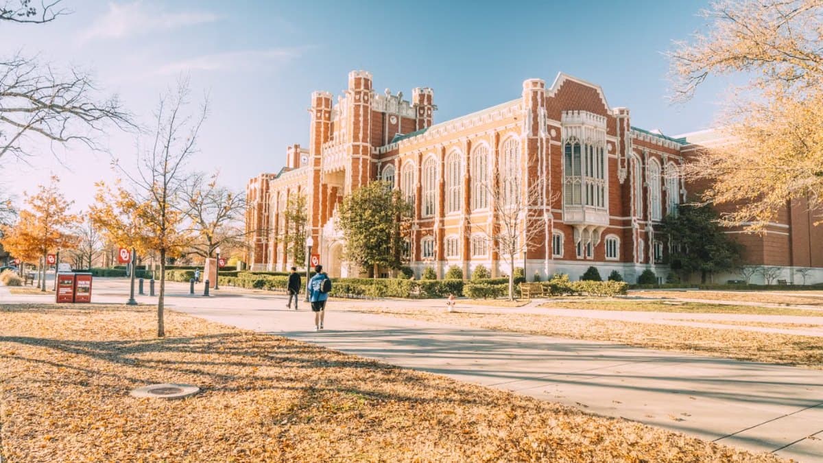 Historic university building surrounded by mature trees