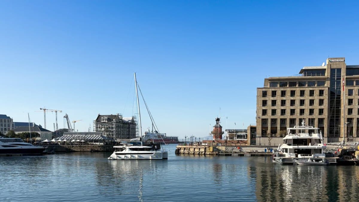 Marina with moored boats along a city waterfront