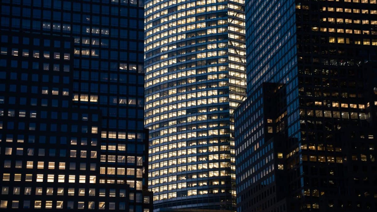 City skyscrapers with glowing windows at night