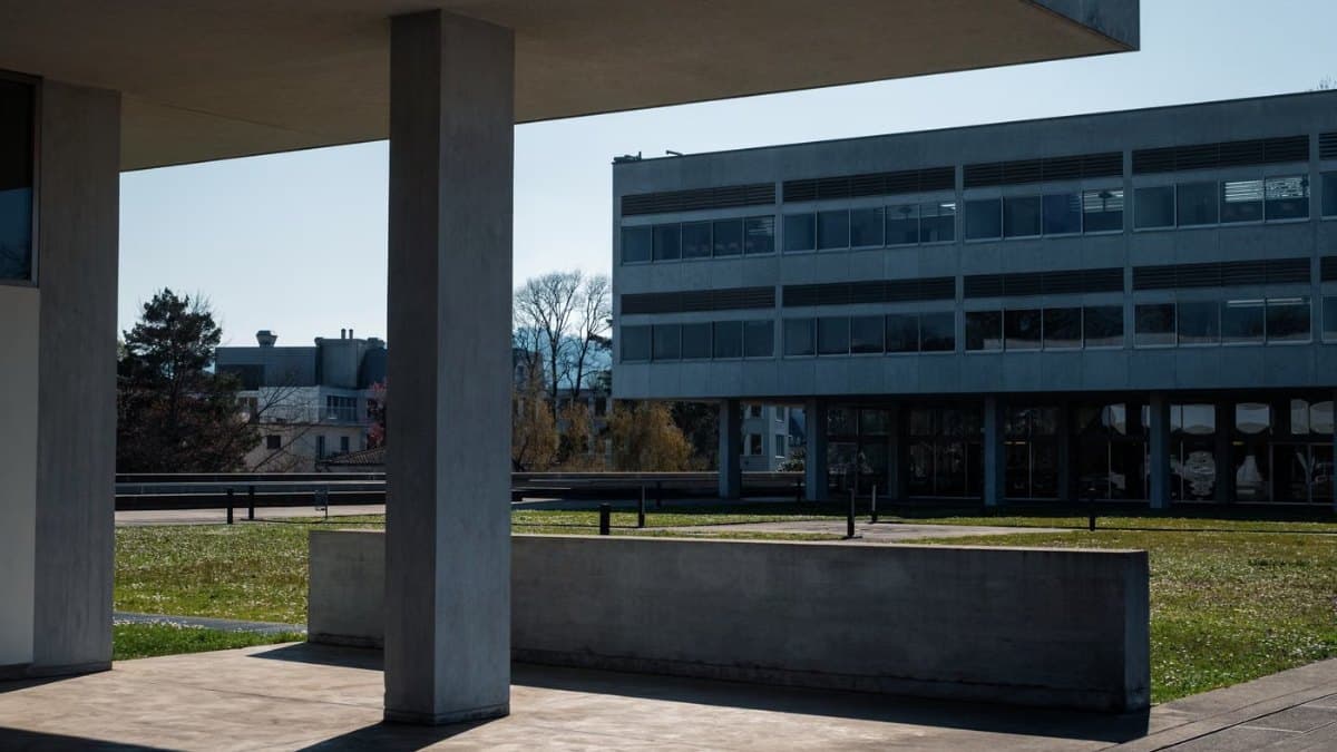 Modern university building beside an open green space