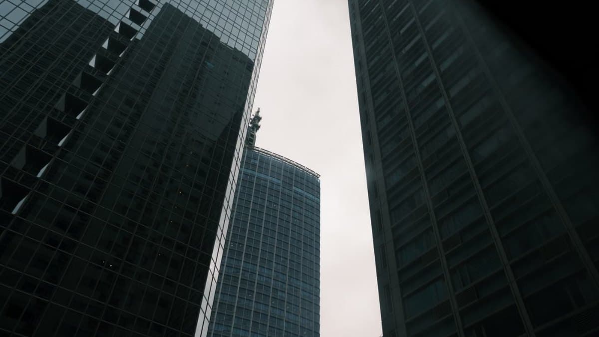 Modern glass office towers reaching into an overcast sky