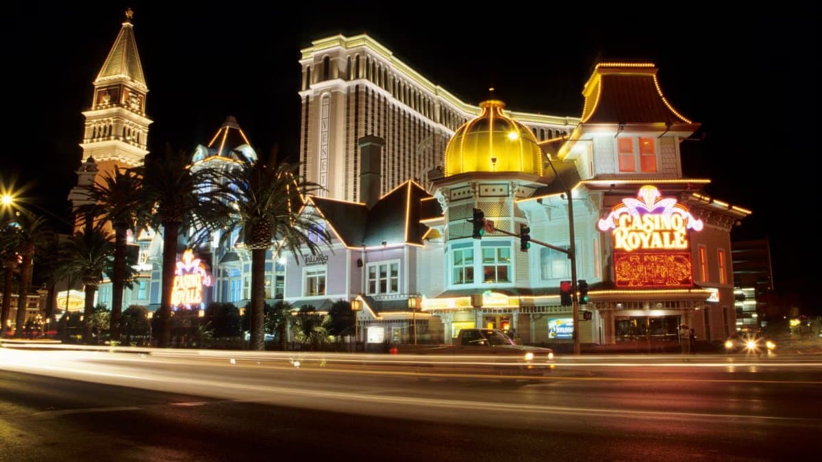 Vibrant nightlife scene with bright casino lights along a busy street