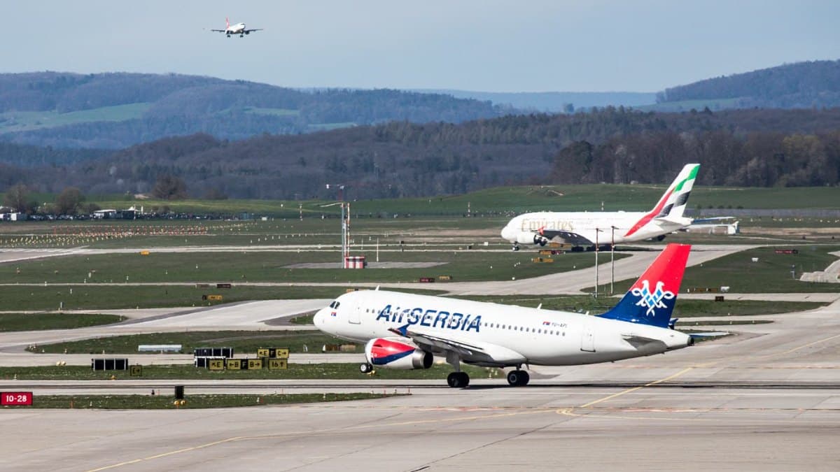 Airplanes taking off and landing at a busy international airport