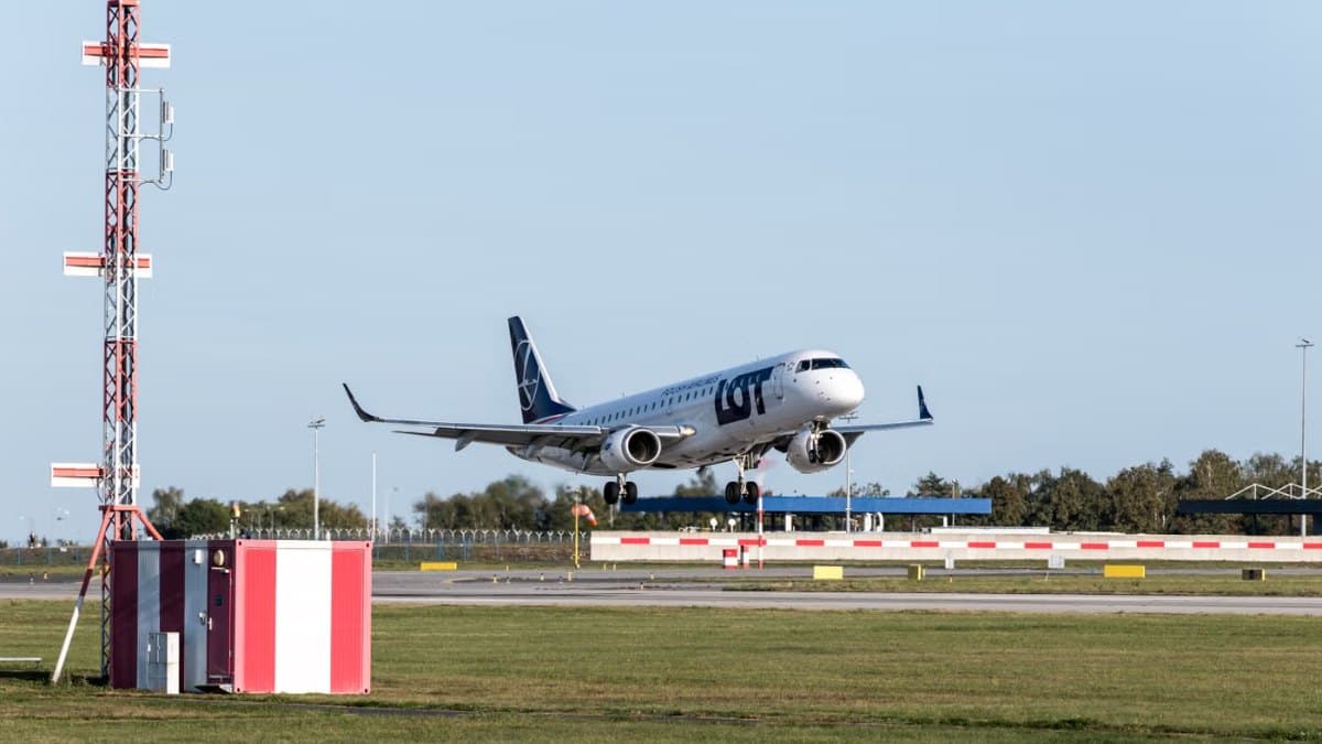 Airliner taking off from an airport runway on a clear day