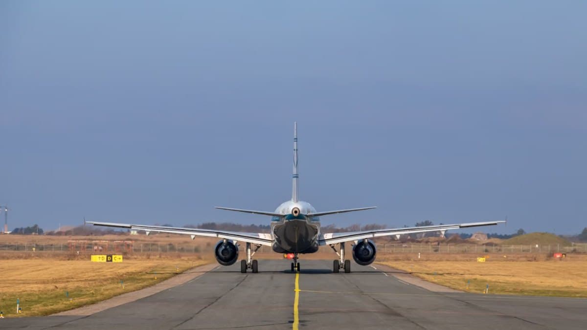 Commercial airplane taxiing on a runway on a clear day