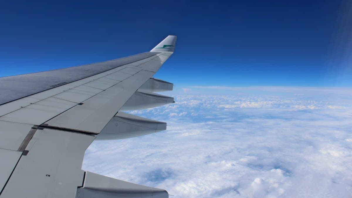 Airplane wing above clouds during a flight
