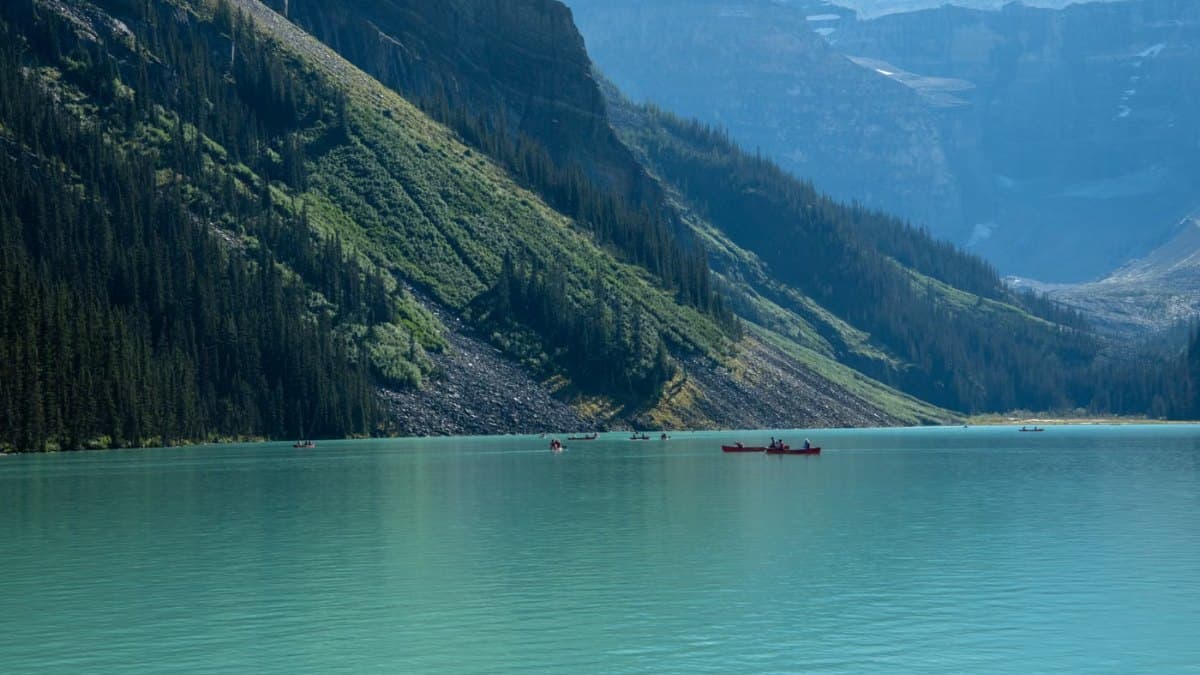Canoes on the turquoise waters of Lake Louise surrounded by mountains