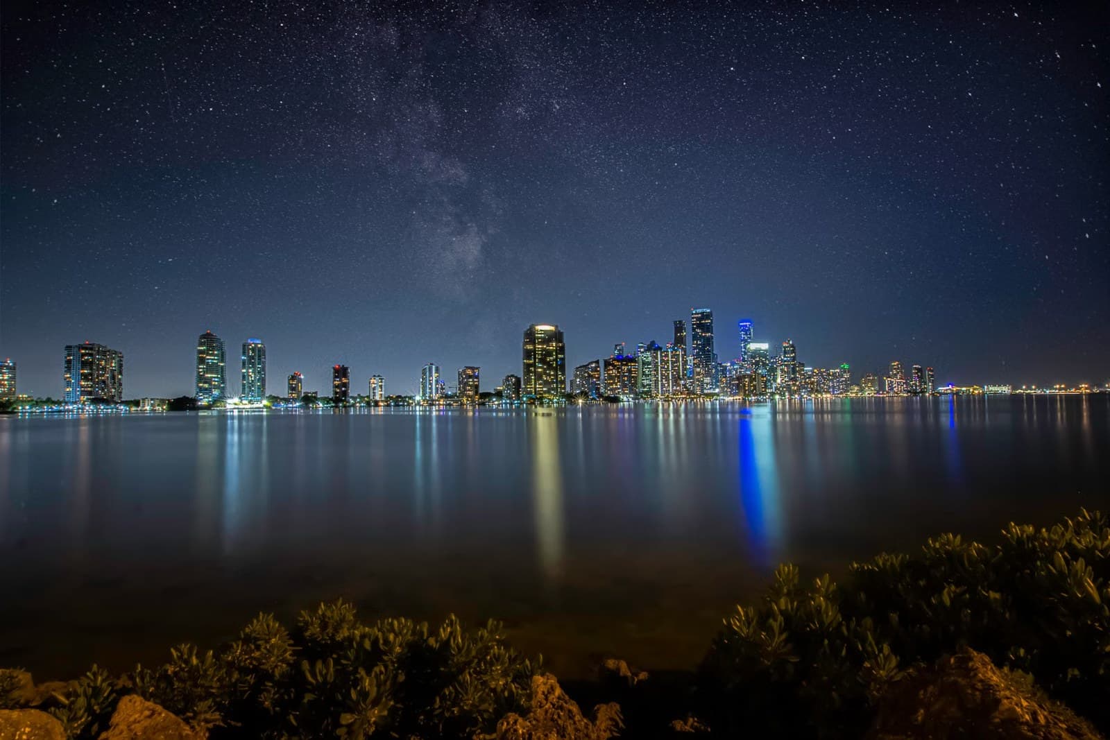 Miami skyline at night with the port and cruise terminals in the distance