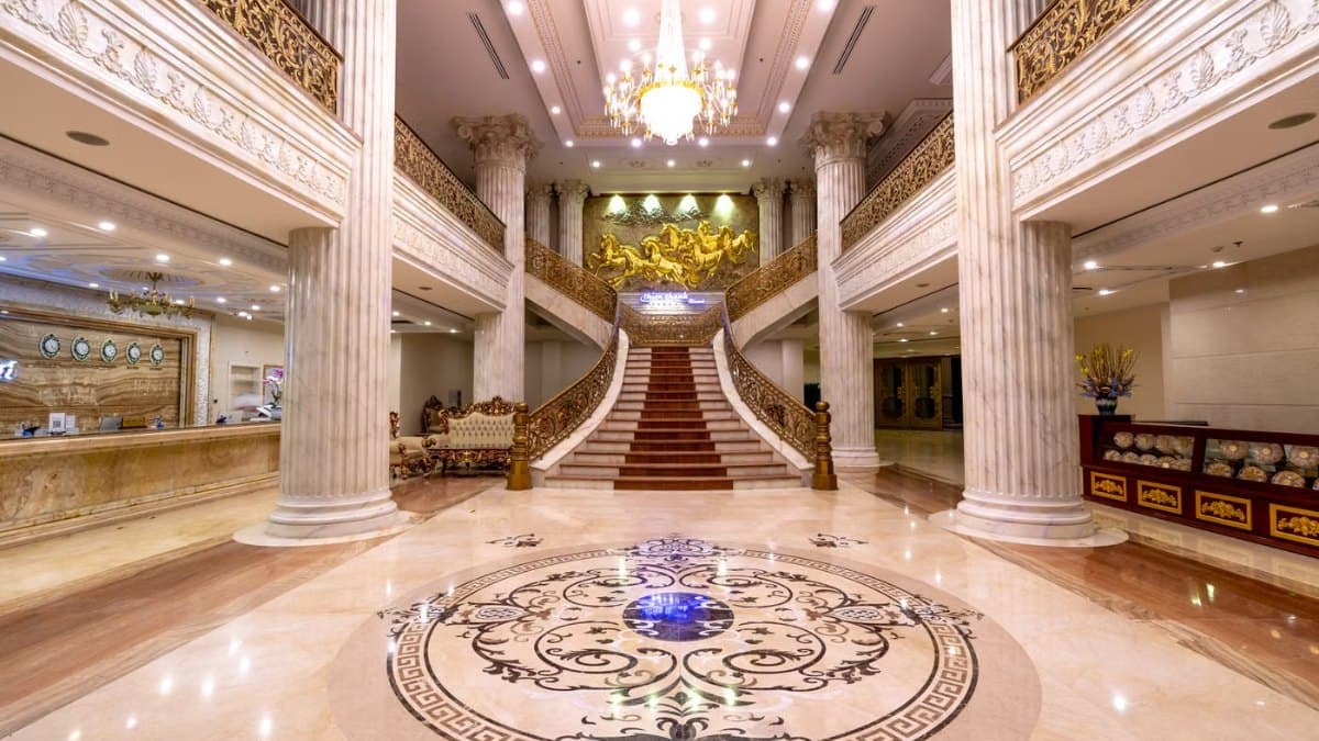 Elegant hotel foyer with marble floors and a grand staircase in Toronto