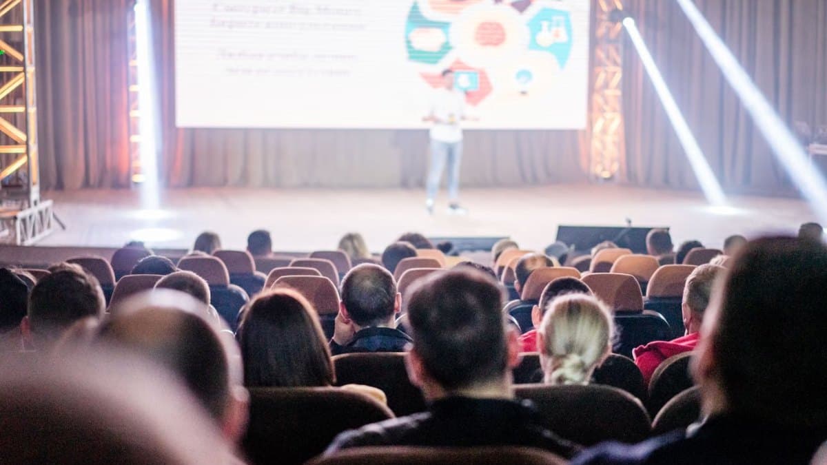 Delegates attending a large conference presentation in Toronto