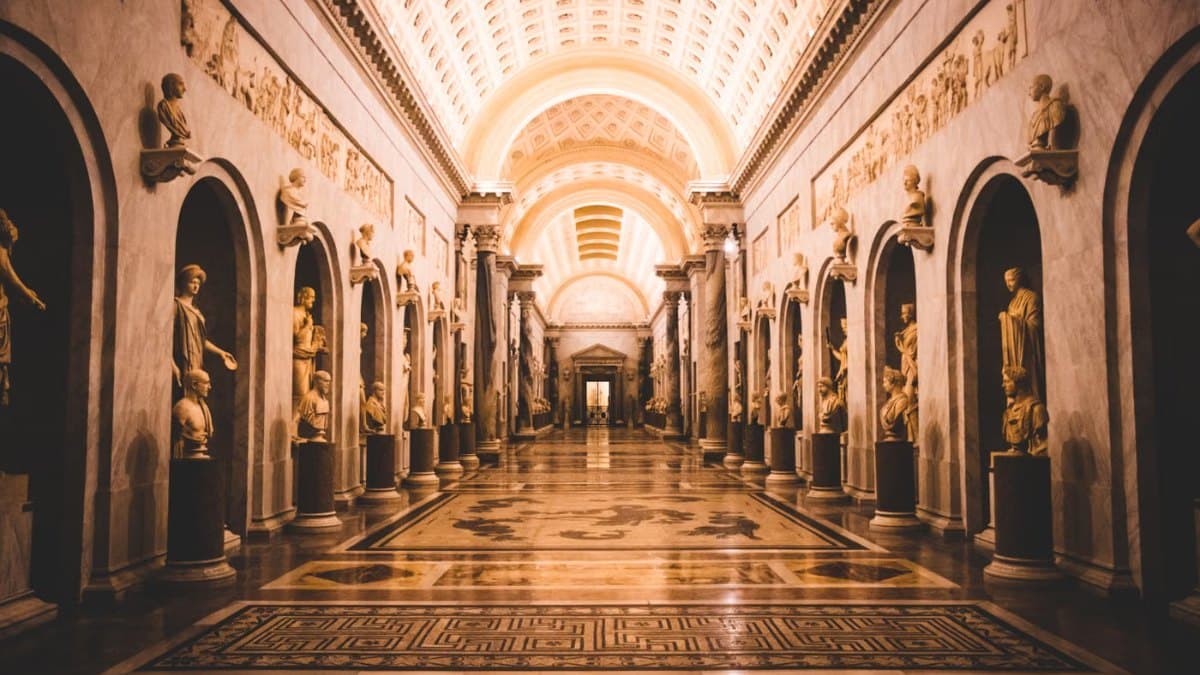 Museum hallway lined with classical sculptures