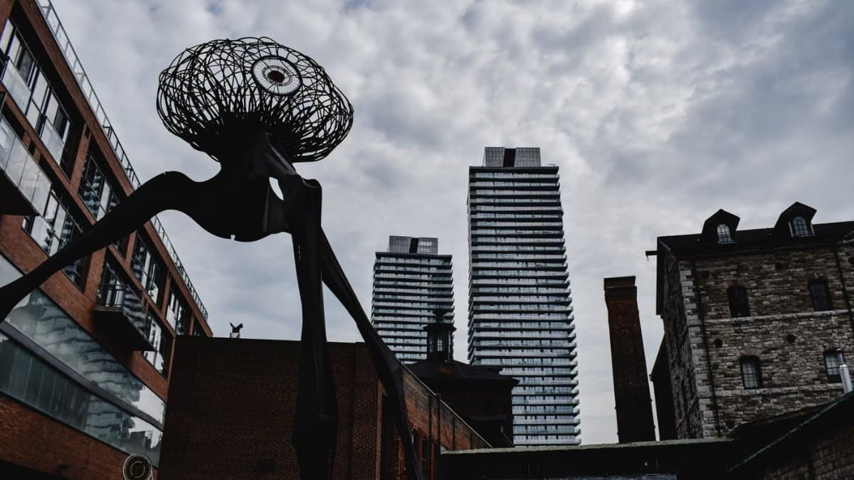 Dramatic sculpture against the urban skyline of Toronto