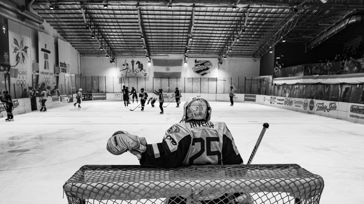 Ice hockey goalie during a match in black and white