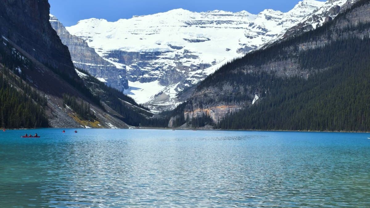 Mountain lake with blue water and snowy peaks