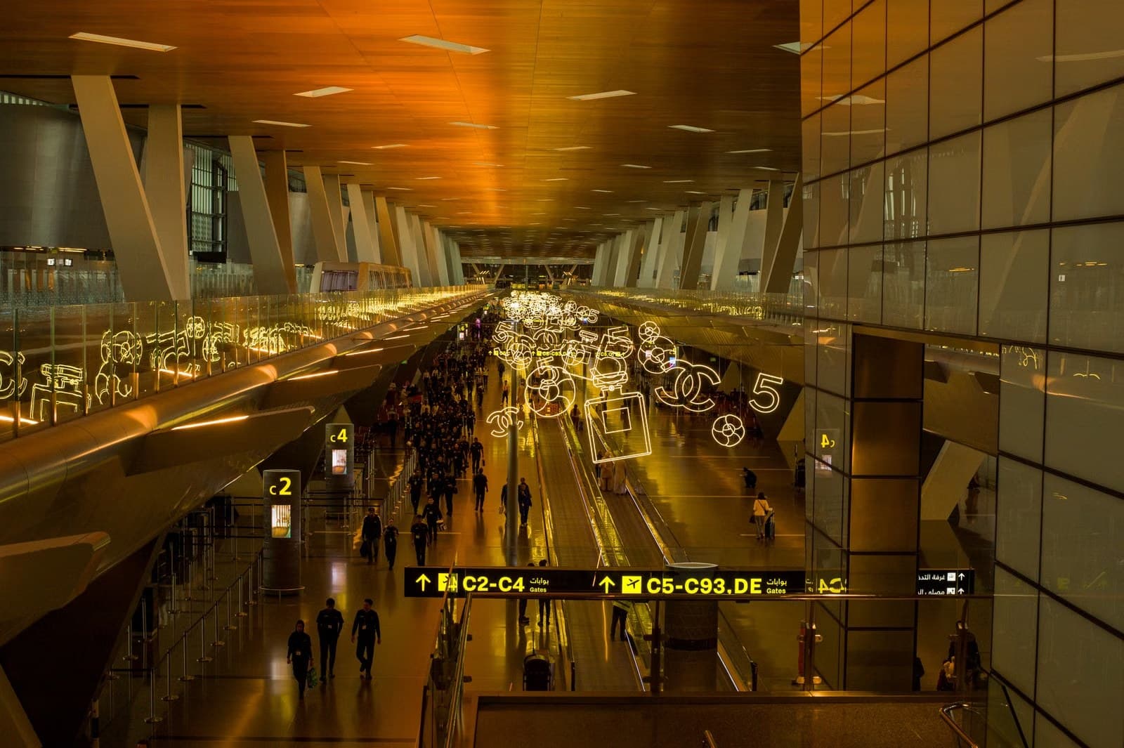Busy airport terminal with modern architecture and lighting