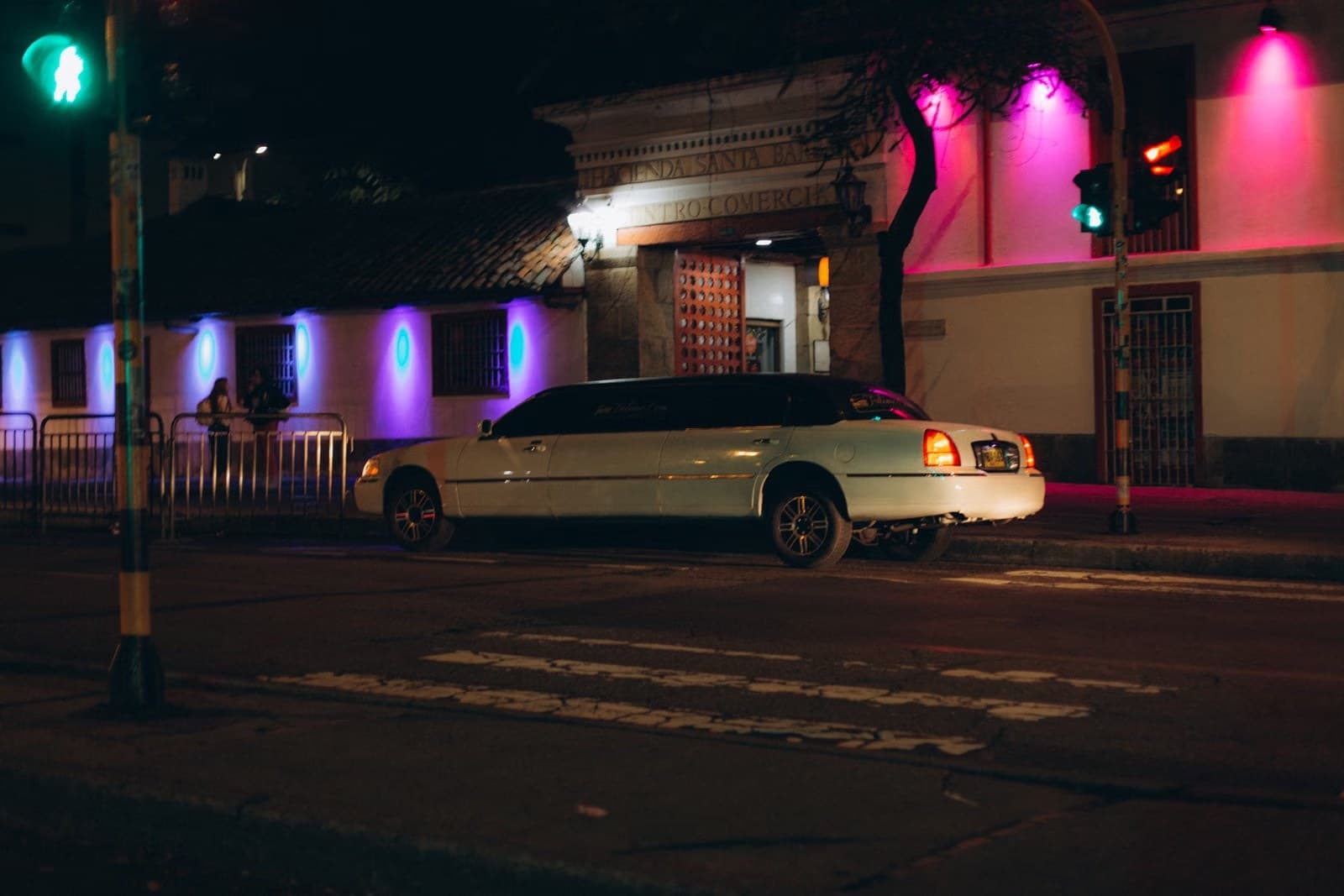 Luxury black car parked on a city street at night